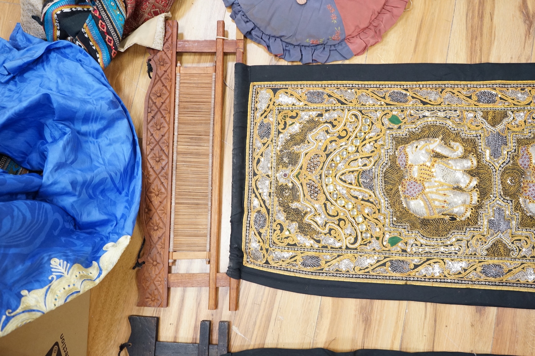 A quantity of mostly 20th century Middle Eastern and Indian woven and printed textiles and a peacock feather fan (2 boxes).